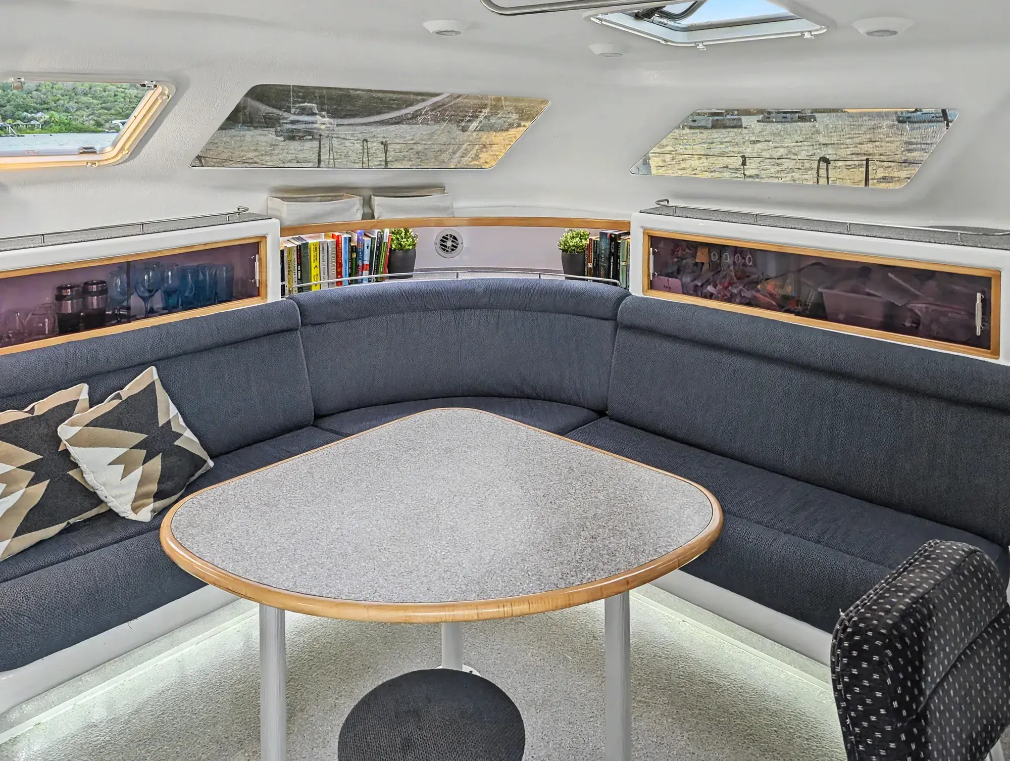Voyage 500 catamaran salon interior — Sunbrella settee, Corian work surfaces, and panoramic windows